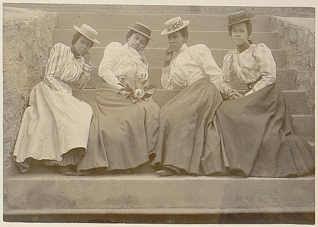 [Four African American women seated on steps of building at Atlanta University, Georgia]