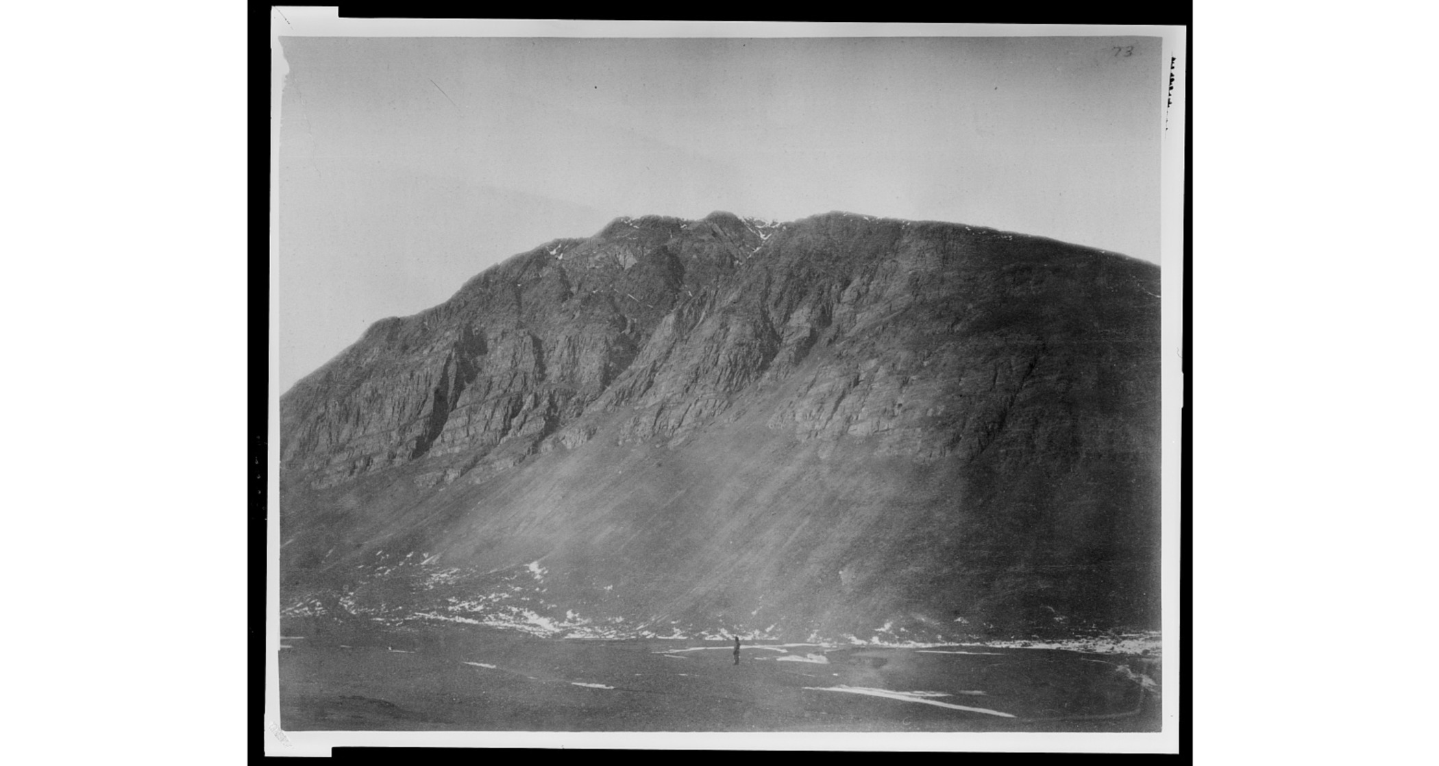 Man standing in front of mountain during the Lady Franklin Bay Expedition